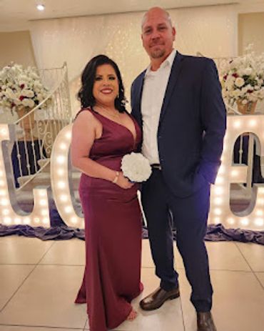 man standing in his new suit with his wife