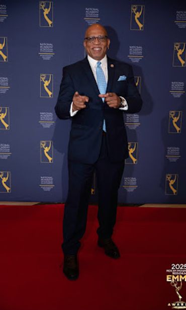 A gentleman in his new navy-blue suit at the Emmy awards
