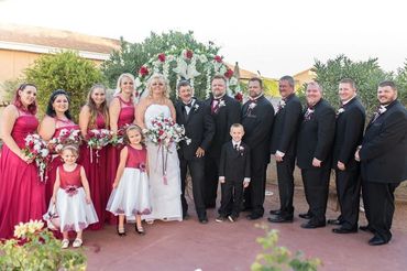 large wedding party with bridesmaids on one side and the groomsmen on one side in their suits