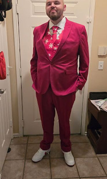A man standing in his 3-piece red suit