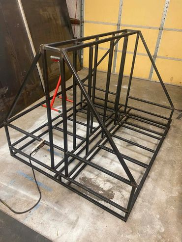 Metal frame structure on a workshop floor.