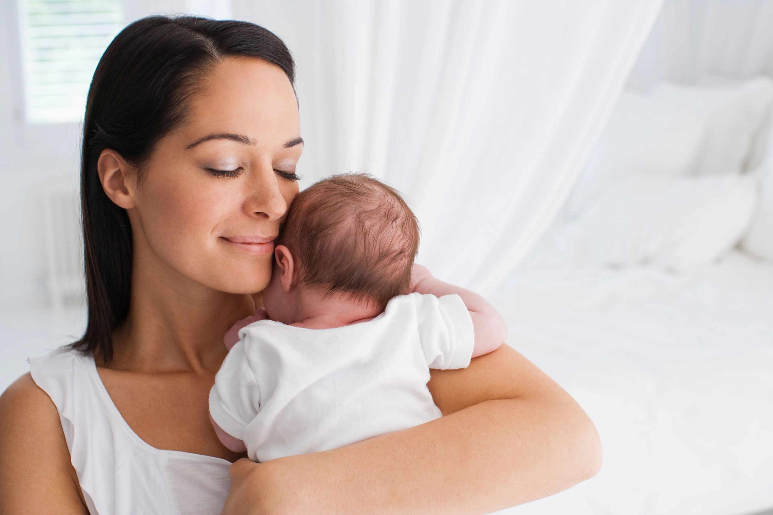 mother gushing newborn baby after having parental burnout treatment
