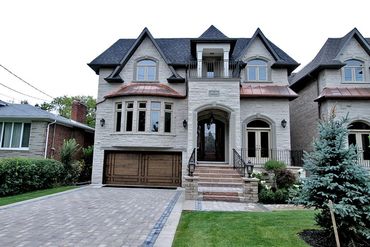 A pair of modern luxury residences designed with open-concept layouts, large windows, and refined ar