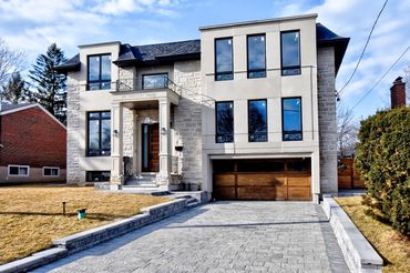 A striking modern residence featuring clean lines, large windows, and bright open-concept interiors.