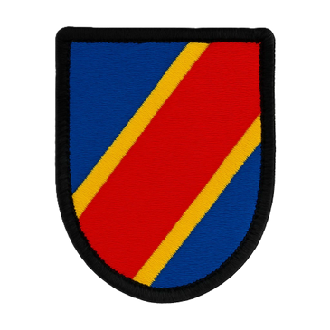Embroidered shield patch with red, blue, and yellow diagonal stripes.