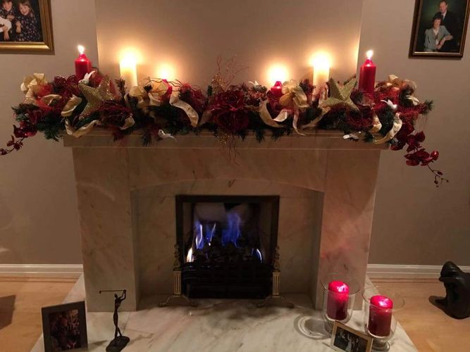 Candle lit swagged fireplace