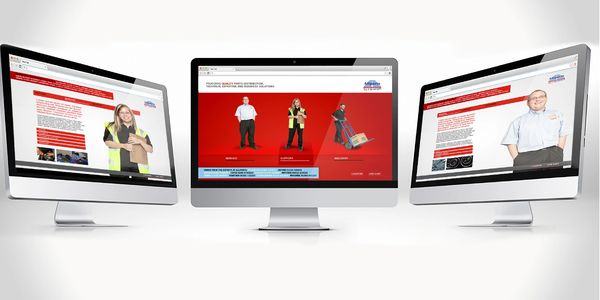 Three desktop monitors displaying a warehouse safety website.