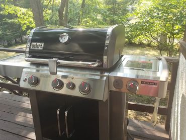 Weber Genesis II Special Edition gas grill on a wooden deck.