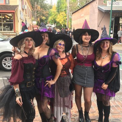 A gaggle of beautiful witches on Main Street at the Murphys Witch Walk Halloween Festival and Party