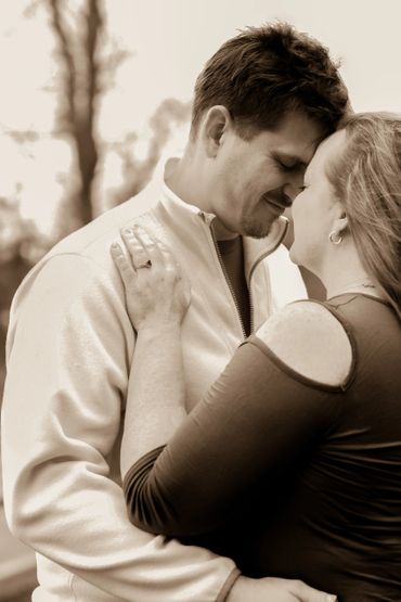 A couple sharing an intimate and loving moment outdoors.