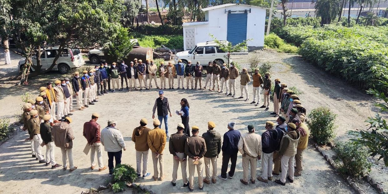 Group of people standing in a large circle outdoors.