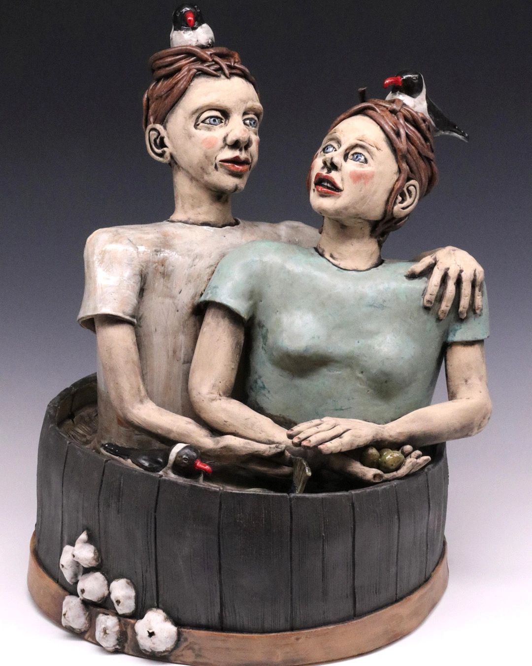 Ceramic couple floating in a barrel visted by laughing gulls