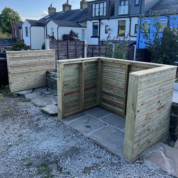 Newly built wooden garden structures in a residential backyard.