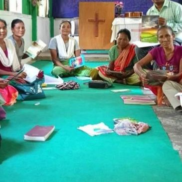 Women sitting in a circle inside a church.