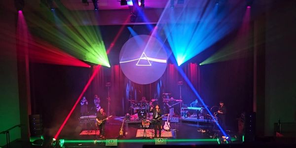 Artemidorus - Pink Floyd tribute band inside the multi colored light triangle on stage. 