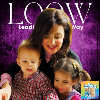 Woman smiling with two young children against a purple backdrop.