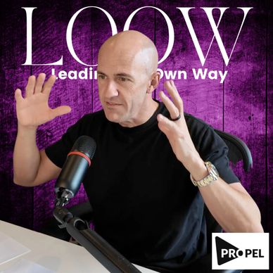 Man speaking passionately into a microphone with LOOW background.