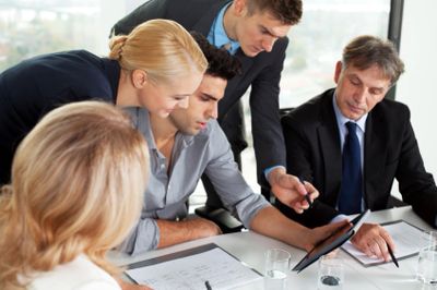 Colleagues collaborating on a project in a modern office setting.