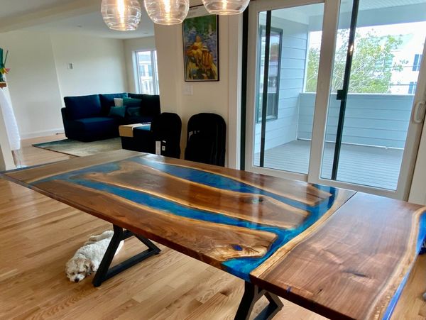 Dining room table with two pull out leaves made from black walnut with blue, till and clear epoxy. t