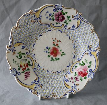 Decorative ceramic plate with floral patterns and blue accents.