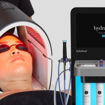 Person undergoing hydrafacial treatment with LED light therapy.