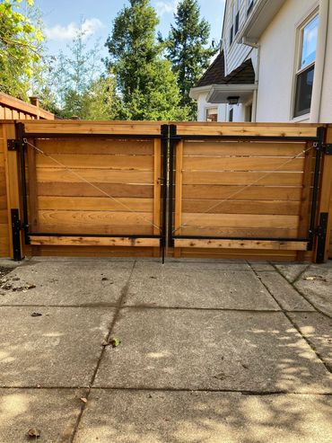 Back view horizontal double drive gate system Portland Oregon cedar fence and gate installation 