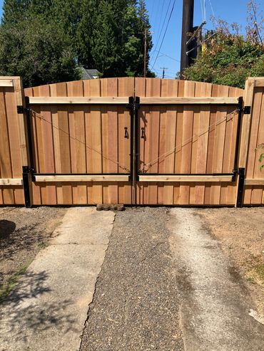 Round top overlap double drive gates back view 
Portland Oregon cedar fence and gate installation 