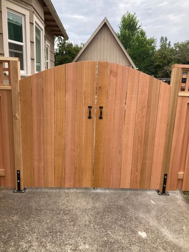 Solid style round top double drive gates front view Portland Oregon cedar fence and gate installatiop