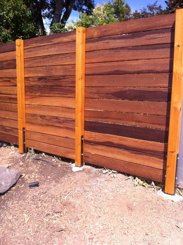 Hardwood horizontal fence with exposed posts and no top cap board 