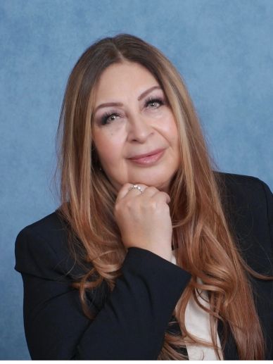 Woman posing thoughtfully with hand on chin.