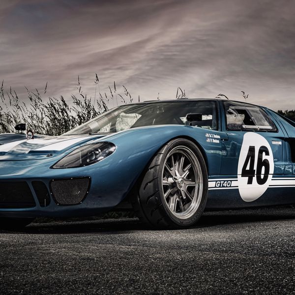 Blue vintage racing car with number 46 on the door.