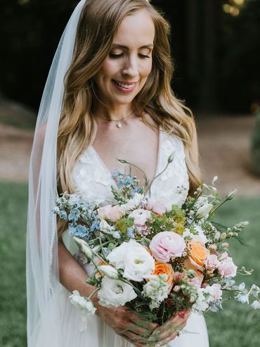 bride holding pastel garden-inspired bridal bouquet at The Mountain Terrace venue in Woodside, CA