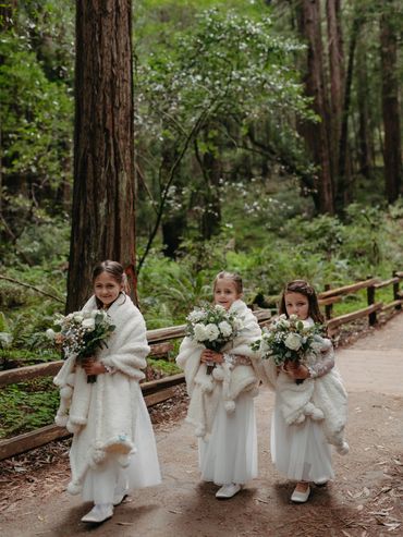Little flower girls with bouquets at John Muir woods for intimate wedding ceremony
