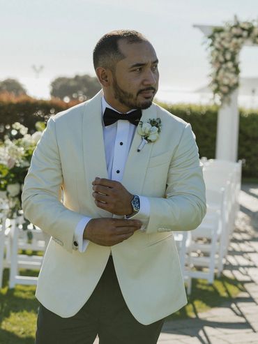 Groom with phalaenopsis orchid boutonniere ivory greenery Oceano Hotel and Spa, Half Moon Bay, CA 