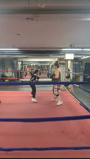 Child and Parent learning to channel emotions together through boxing.