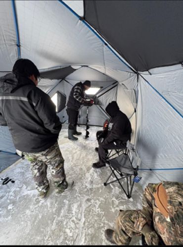 Learning how to set up an ice fishing lodge and the proper way to use the Auger.