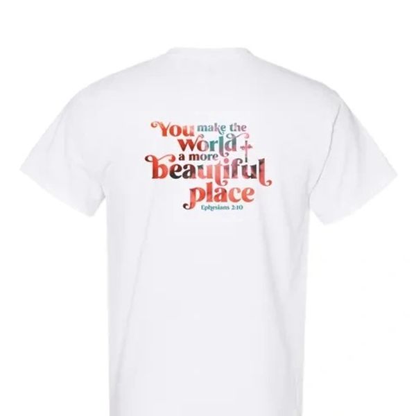 White shirt with colorful inspirational quote on back.