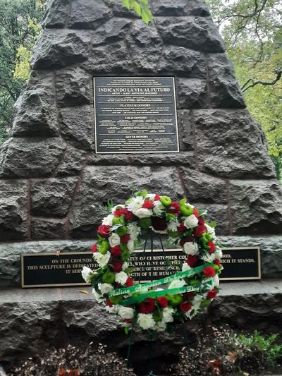 "Happy Columbus Day" wreath placed at the Columbus monument plinth in New Haven on October 13, 2025.