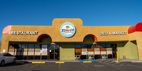 Front view of Rincon restaurant and deli market with bright blue sky.