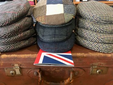 British flat caps displayed on suitcase