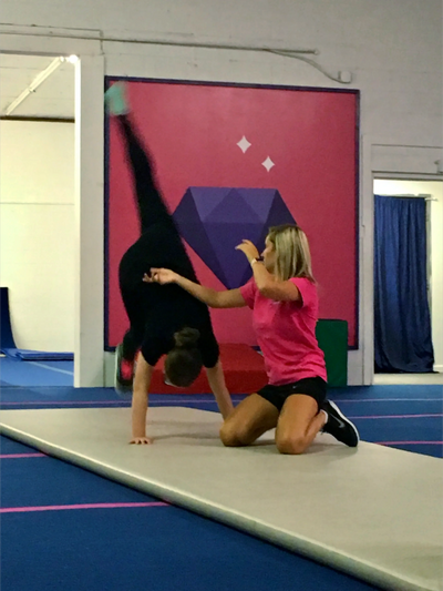 Coach assisting tumbler