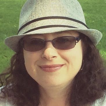 Photo of Piper Terrett wearing a hat and glasses. 