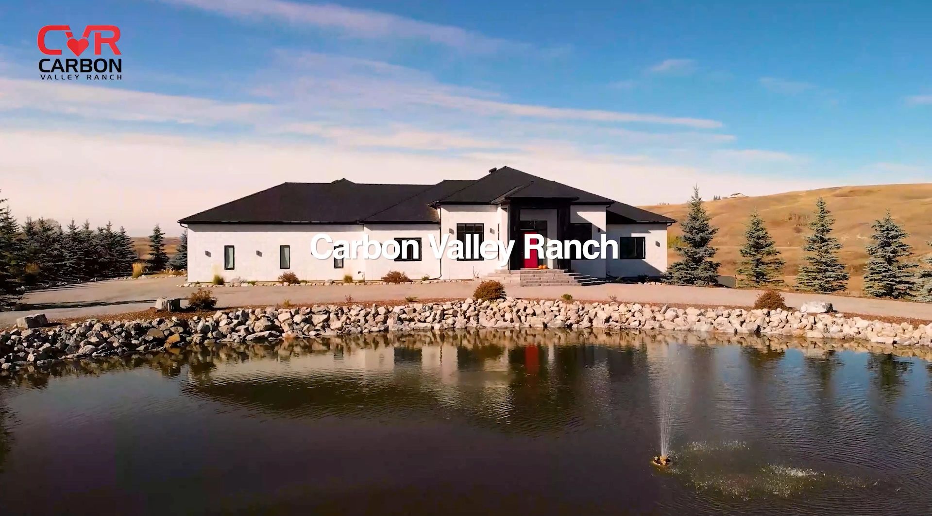 Modern ranch home with a pond and fountain.