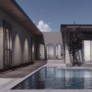 Modern house with a swimming pool and arched windows under a clear sky.