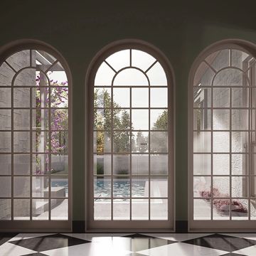 Elegant room with arched windows overlooking a pool and checkered floor tiles.