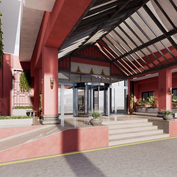 Modern entrance with red pillars, glass doors, and a transparent roof.