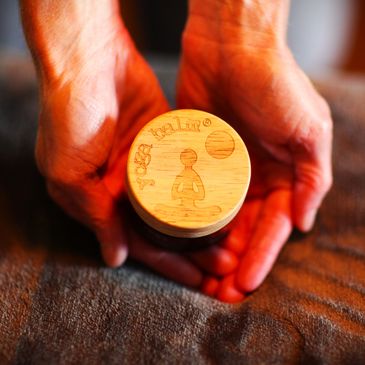 A person holding a wooden stamp on the display
