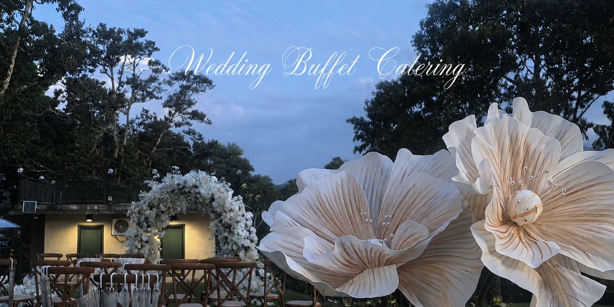 Elegant outdoor wedding setup with floral decorations and buffet catering.