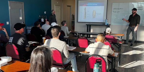 Students listening to an instructor teach fundamentals of the Canadian Firearms Safety Course.