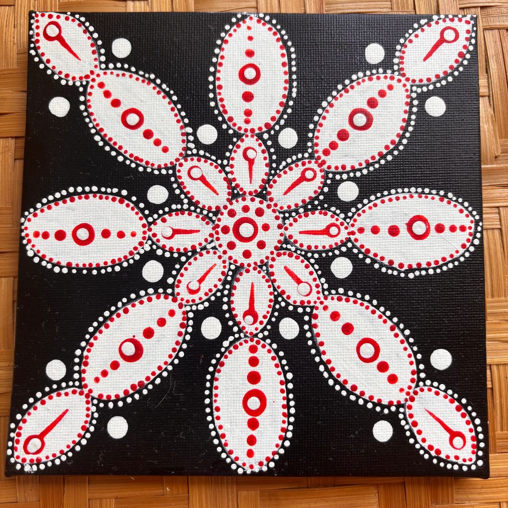 Abstract dot painting with red, white, and black patterns.